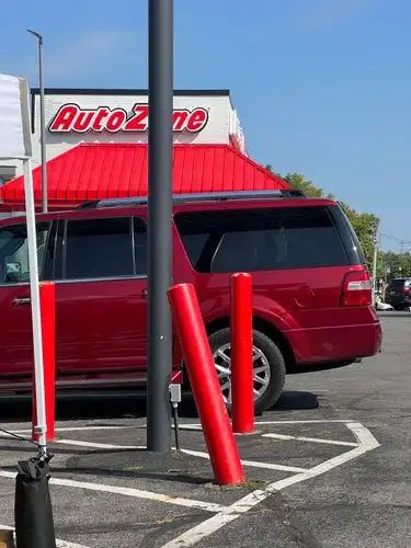 Red on red, parked at AutoZone.